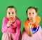 Happiness and dessert. Sisters with round and long shaped lollipops.