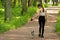 Happiness, emotions, family values â€‹â€‹concept. Girl walking a dog in the park