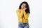 Happiness, emotions and people concept. Attractive lovely african-american woman, curly-haired in yellow sweater, tilt