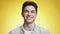 Happiness and excitement concept. Young cheerful caucasian guy laughing to camera over yellow studio background