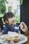 Happiness face of asian children with sweet dessert on table foreground