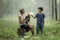 Happiness and harmony in family life. Happy family concept. Old father smiling with his daughter in the rubber trees field.