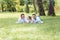 Happiness and harmony in family life. Happy family concept. Young mother and father with their daughter in the park. Happy family