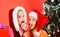 Happiness and holidays concept. Girls celebrate Christmas eating candies