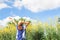 Happiness long hair woman in casual clothing with yellow flowers field