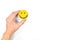 Happiness and positivity concept. Hand holding yellow smiling face in white background with copy space.