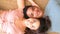 Happiness in relationship interracial young adult man and woman lay down on the floor at home and smiling together with joy -