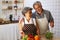 Happiness senior elderly couple having fun in kitchen with healthy food for working from home.