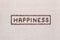 Happiness sign from coffee beans on linea texture, aligned center