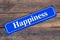 Happiness street sign on wooden background