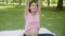 Happiness young asian woman pregnant sitting doing sport exercise with stretch hands muscle for health care at park.