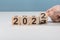 Happy 2023 new year concept, Flipping of wooden cube block change from 2022 to 2023. Start new year 2023 with goal plan, goal