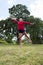 Happy 20s woman jumping for joy in sunny outdoors