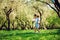 happy 3 years old child boy catching butterflies with net on the walk in sunny garden or park. Spring and summer outdoor activitie