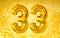 Happy 33 thirty three number on a golden background