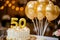 Happy 50th birthday. Gold helium 50 birthday balloons on a birthday cake