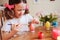 Happy 7 years old kid girl painting easter eggs. Easter craft and holiday preparations