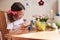 Happy 7 years old kid girl painting easter eggs. Easter craft and holiday preparations