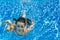 Happy active child swims underwater in pool