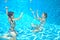 Happy active kids swim in pool and play underwater