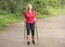 Happy active senior woman nordic walking in the park