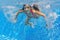 Happy active underwater child swims and dives in pool