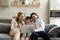 Happy adolescent boy using computer with couple parents.