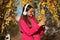 Happy adolescent girl on autumn walk listening music. Adolescent girl in fall style. girl in music headphones outdoor