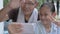 Happy adorable Asian girl with her senior grandfather enjoy taking funny posing selfie photo.
