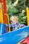 Happy adorable girl on children\'s slide on playground near kindergarten Montessori