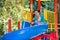 Happy adorable girl with mom on children\'s slide on playground near kindergarten Montessori