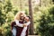 Happy adult caucasian couple in relationship and love play together in the forest wood nature - outdoor people leisure activity