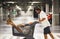 Happy adult couple enjoy and have fun with shopping cart inside a commercial center mall garage. Sales season and family economy