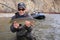 Happy adult fisherman holding steelhead trout