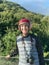 Happy adult photographer with red helmet getting ready to ride an all terrain vehicle