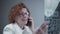 Happy adult woman doctor radiologist discussing CT scan of patient\'s lungs with colleagues by phone in hospital office