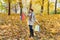 Happy adult woman with shopping bags walking in autumn Park. Autumn sale discounts