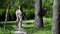 happy adult woman is walking alone in park at sunny morning, strolling barefoot over path