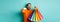 Happy aduly man showing credit card and shopping bags, standing against turquoise background