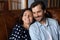 Happy affectionate man and woman resting on cozy sofa.