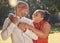 Happy affectionate mature african american couple sharing an intimate moment outside at the park during summer. In love