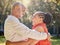 Happy affectionate mature african american couple sharing an intimate moment outside at the park during summer. In love