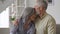 Happy affectionate mature husband embracing kissing wife enjoying tenderness.