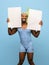 Happy Africam-American man in swimming suit, goggles isolated on blue background