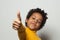 Happy African American child boy showing thumb up on white background