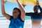 Happy african american couple carrying yellow surfboard over heads at beach