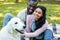 happy african american couple palming white dog