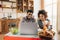 Happy african-american couple using laptop at kitchen