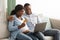 Happy african american expecting family using laptop, shopping online