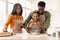 Happy African American Family Baking Pastry Adding Eggs In Kitchen